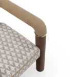 Maudine designer dining chair details by Nolita Harbour, upholstered chair with walnut legs and elegant brass joints.