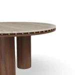 Roselle Dining Table, a modern dining table by Nolita Harbour in stone, walnut, and brass, offering a balanced design.