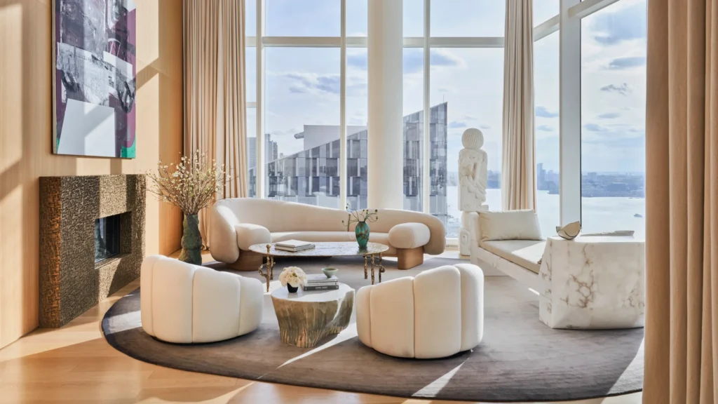 Luxury New York penthouse living room featuring sculptural seating, bespoke furniture, and floor-to-ceiling windows overlooking the city skyline, highlighting design-led New York luxury homes.