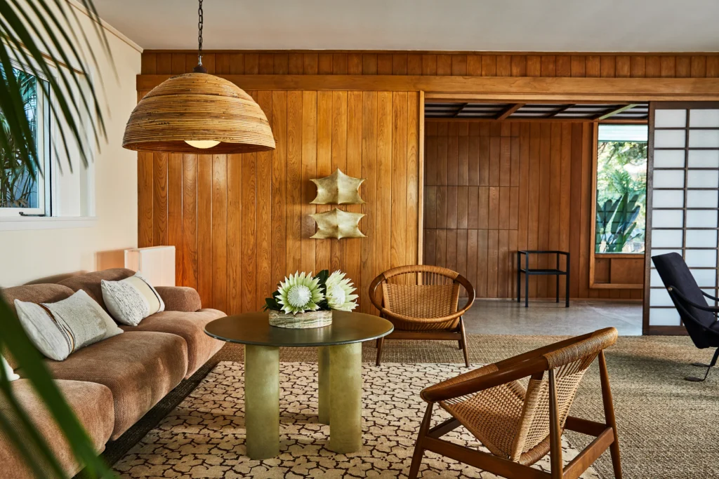 Mid-century modern interior emphasizing wood paneling, tactile materials, and timeless furniture within a modern residential setting