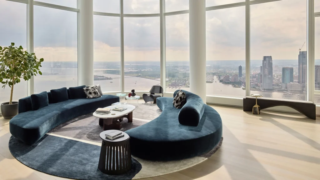 Sophisticated New York living room blending modern living room furniture, soft neutral tones, and architectural columns framing expansive city views.