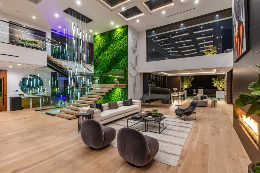 Double-height luxury living room featuring layered lighting design, combining ambient architectural lighting with accent and functional illumination to enhance spatial depth and contemporary interiors.