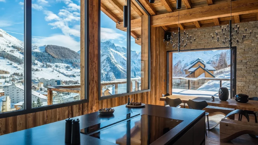 Aspen luxury homes showcasing refined mountain home interior design and seasonal residence furnishing, featuring contemporary alpine architecture, natural wood and stone materials, panoramic mountain views, elegant living rooms with fireplaces, and seamless indoor-outdoor living in Colorado.