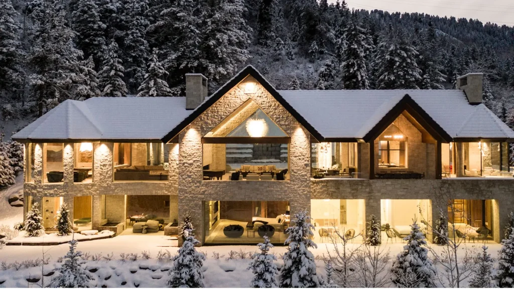 Aspen luxury homes showcasing refined mountain home interior design and seasonal residence furnishing, featuring contemporary alpine architecture, natural wood and stone materials, panoramic mountain views, elegant living rooms with fireplaces, and seamless indoor-outdoor living in Colorado.