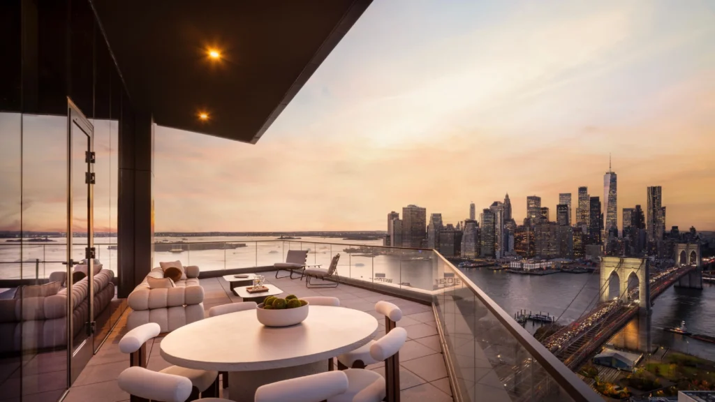 Luxury interior design showcasing Manhattan penthouse interiors with panoramic skyline views and double-height living spaces alongside refined Paris pied-à-terre design in a classic Haussmann apartment, featuring bespoke furniture, natural stone dining tables, artisan-crafted seating, and elegant architectural details blending modern sophistication with historic character.