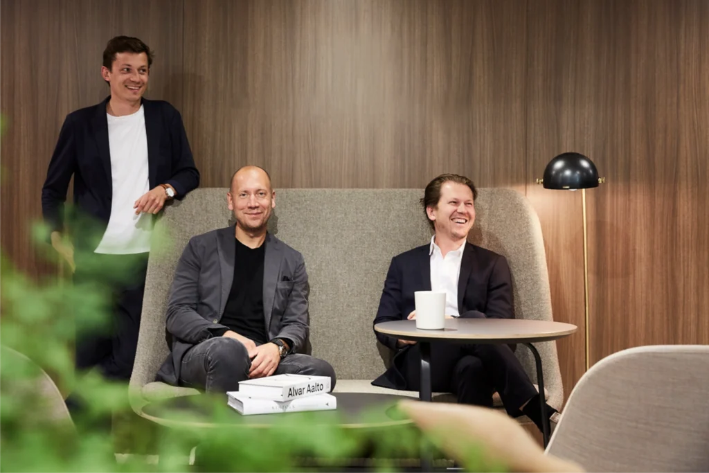 Norm Architects team and selected studio and project interiors showcasing contemporary seating design, minimalist furniture design, and material-driven calm through natural wood, neutral upholstery, and serene architectural settings.