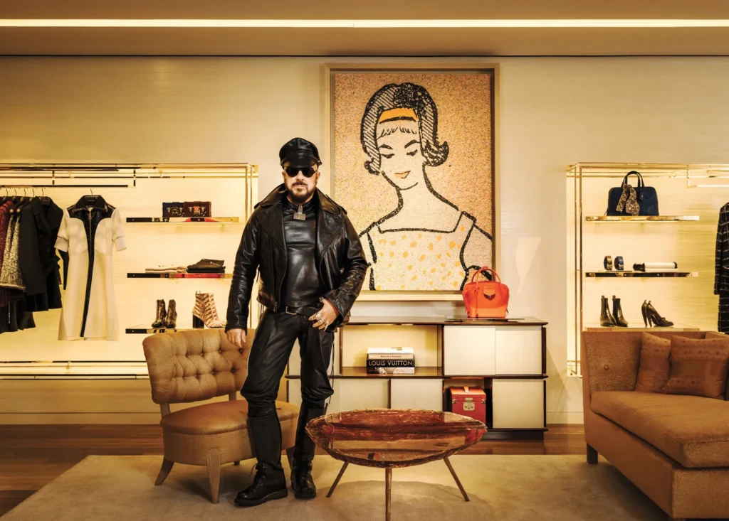 Peter Marino photographed inside a Louis Vuitton interior he designed, embodying his signature aesthetic of black leather, contemporary art, and architectural precision within luxury environments.