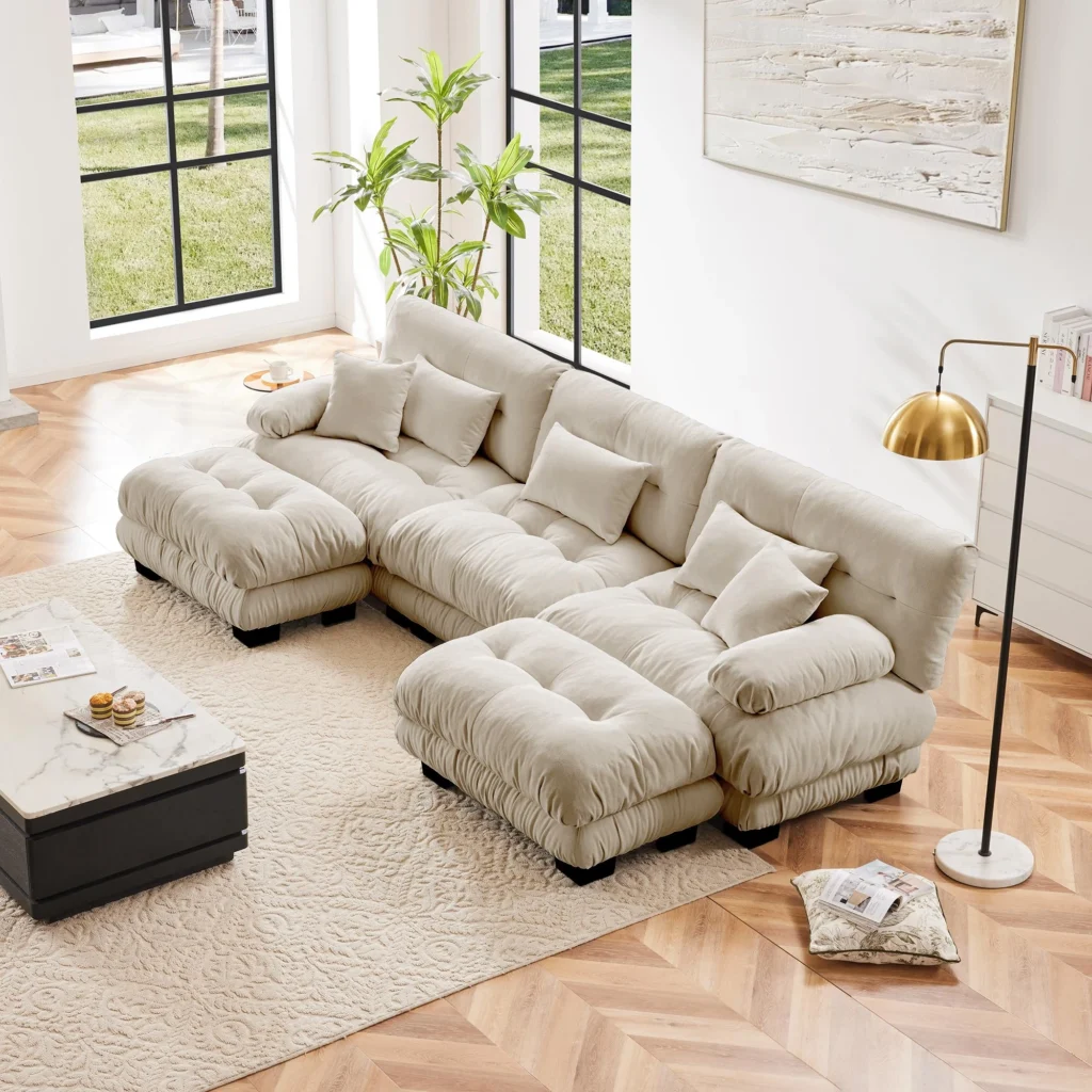 Luxury living room interiors featuring modular sectional sofas with corner modules and chaise lounge units, styled with statement ottomans, layered textiles, and contemporary décor in refined, light-filled residential settings.