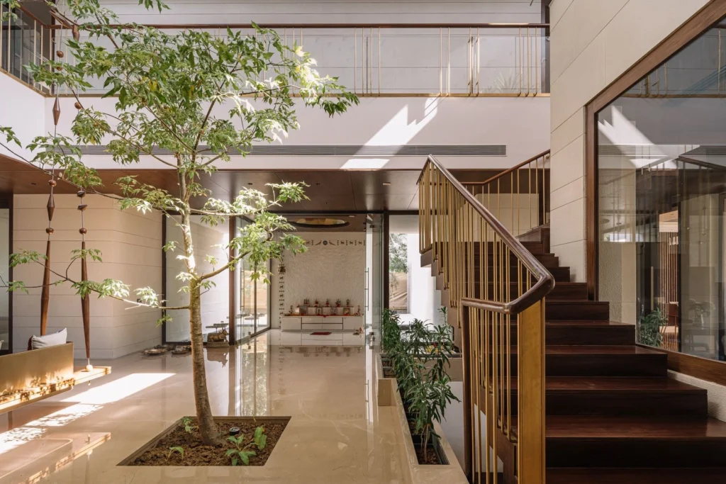 Seamless indoor outdoor living space with sliding glass walls connecting a modern interior to a landscaped courtyard