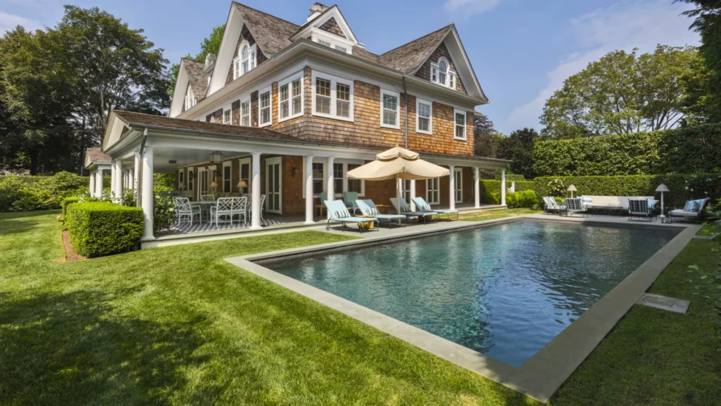 Luxury Hamptons-style East Coast summer home showcasing open-plan coastal interiors, cedar-shingle architecture, landscaped gardens, and a refined infinity pool setting that embodies timeless luxury coastal living.