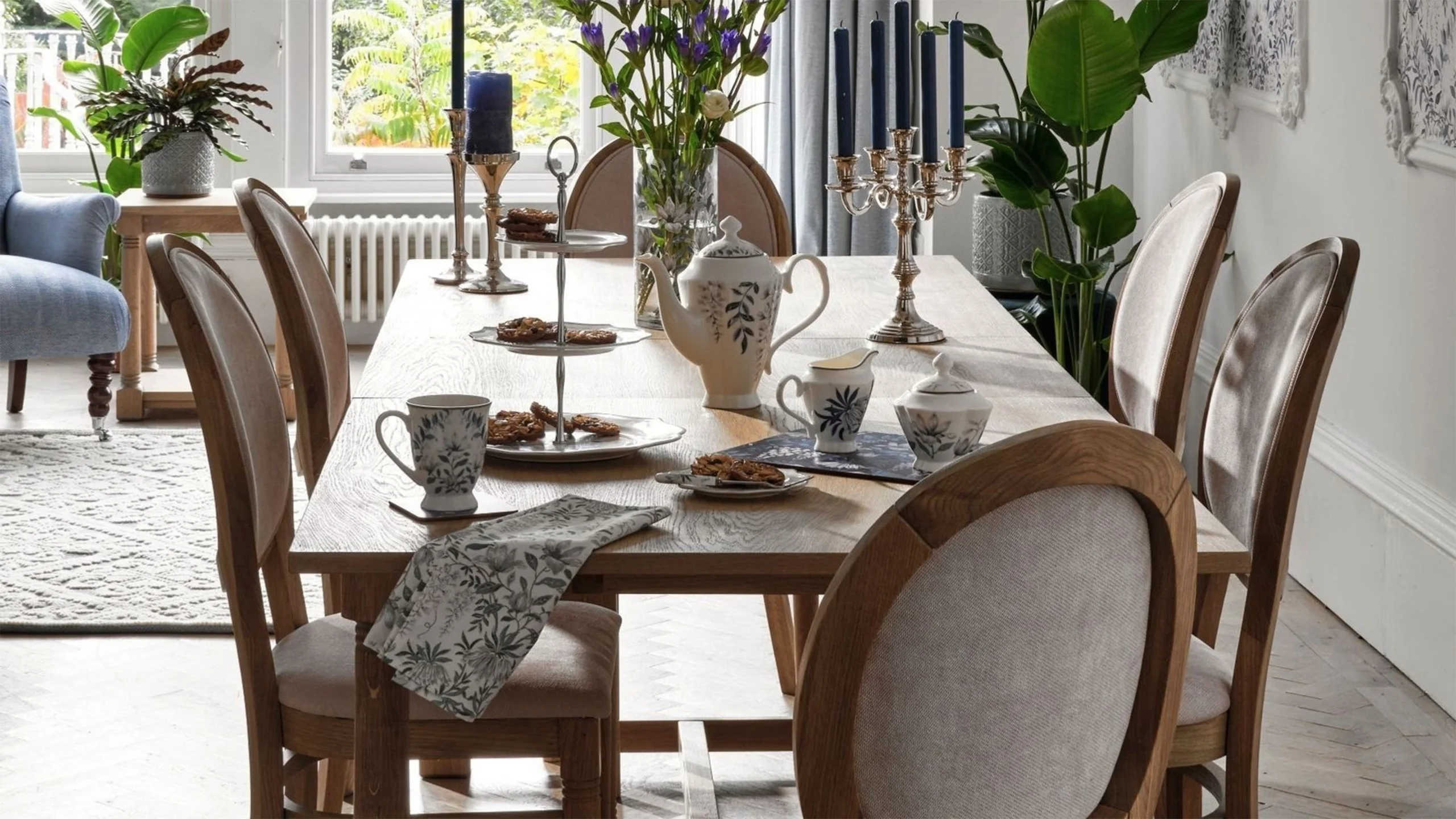 Elegant contemporary dining interiors featuring upholstered dining chairs in neutral and deep tones, sculptural wooden and marble tables, refined lighting, and layered textures that highlight comfort, craftsmanship, and luxury design.