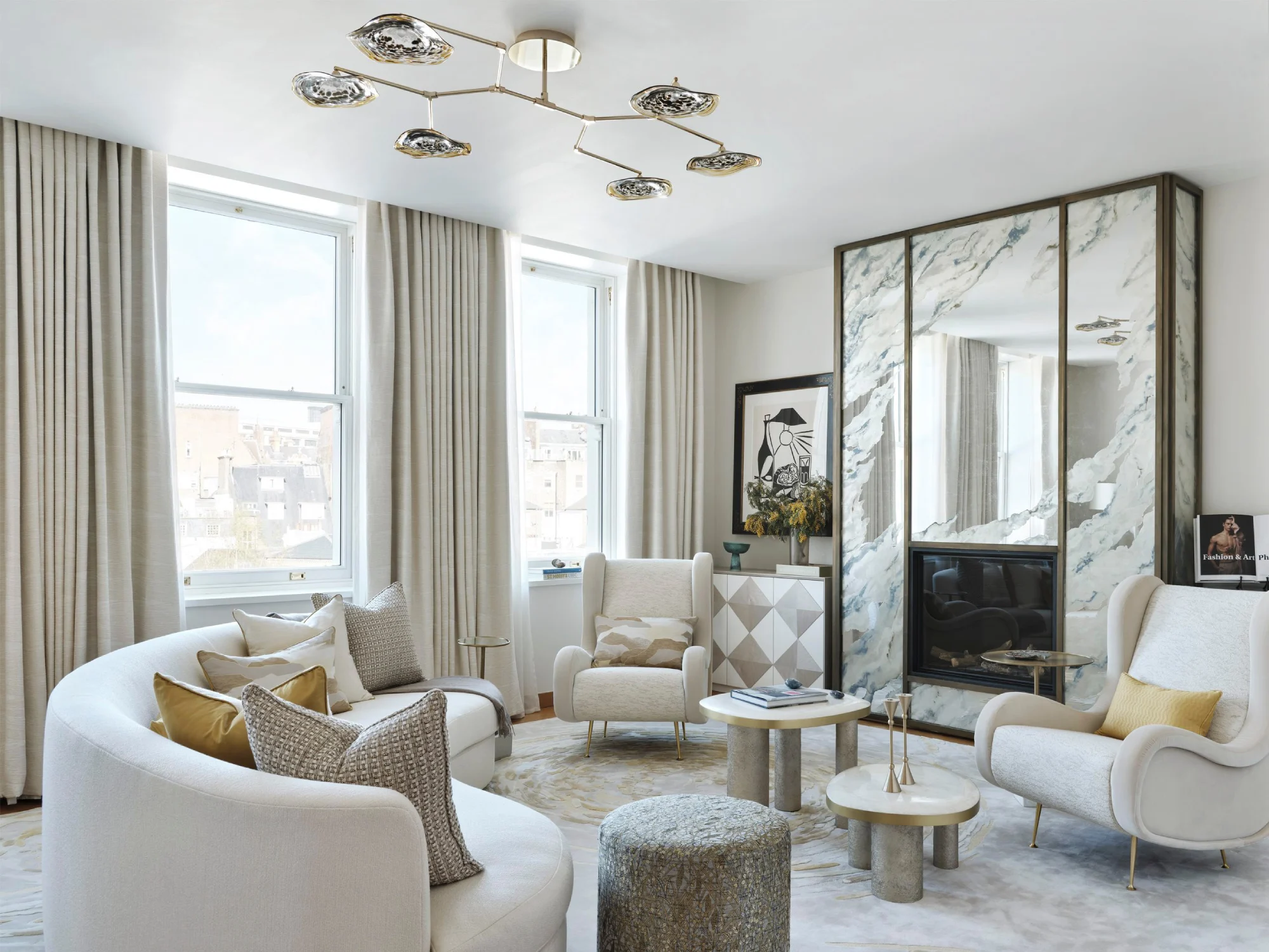 Sophisticated living room featuring contemporary furniture, a large marble mirrored wall, elegant lighting, and pastel accents for a cozy atmosphere.