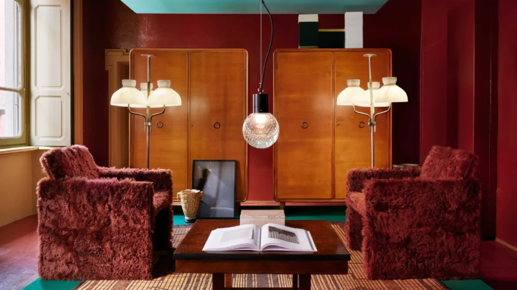 Dimore Studio atmospheric interior design with maximalist layered luxury interiors, velvet furniture, vintage lighting and moody Milanese aesthetic