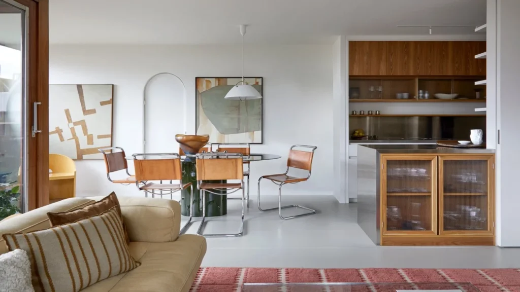 Barbican Estate brutalist apartments in London featuring split-level interiors, concrete architecture, landscaped terraces, and iconic modernist towers.
