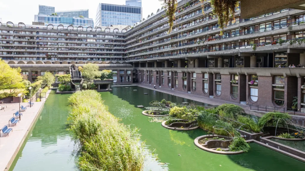 Barbican Estate brutalist apartments in London featuring split-level interiors, concrete architecture, landscaped terraces, and iconic modernist towers.