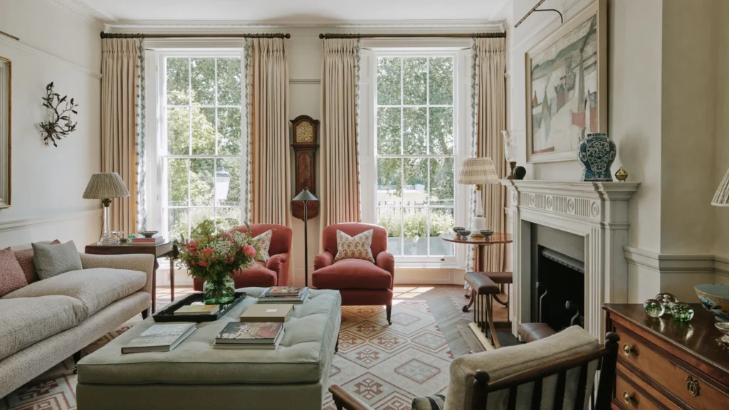 Chelsea townhouse interiors showcasing a refined parlor floor living room layout with floating seating, preserved historic windows, marble fireplaces, and thoughtful historic home furniture placement bathed in natural light