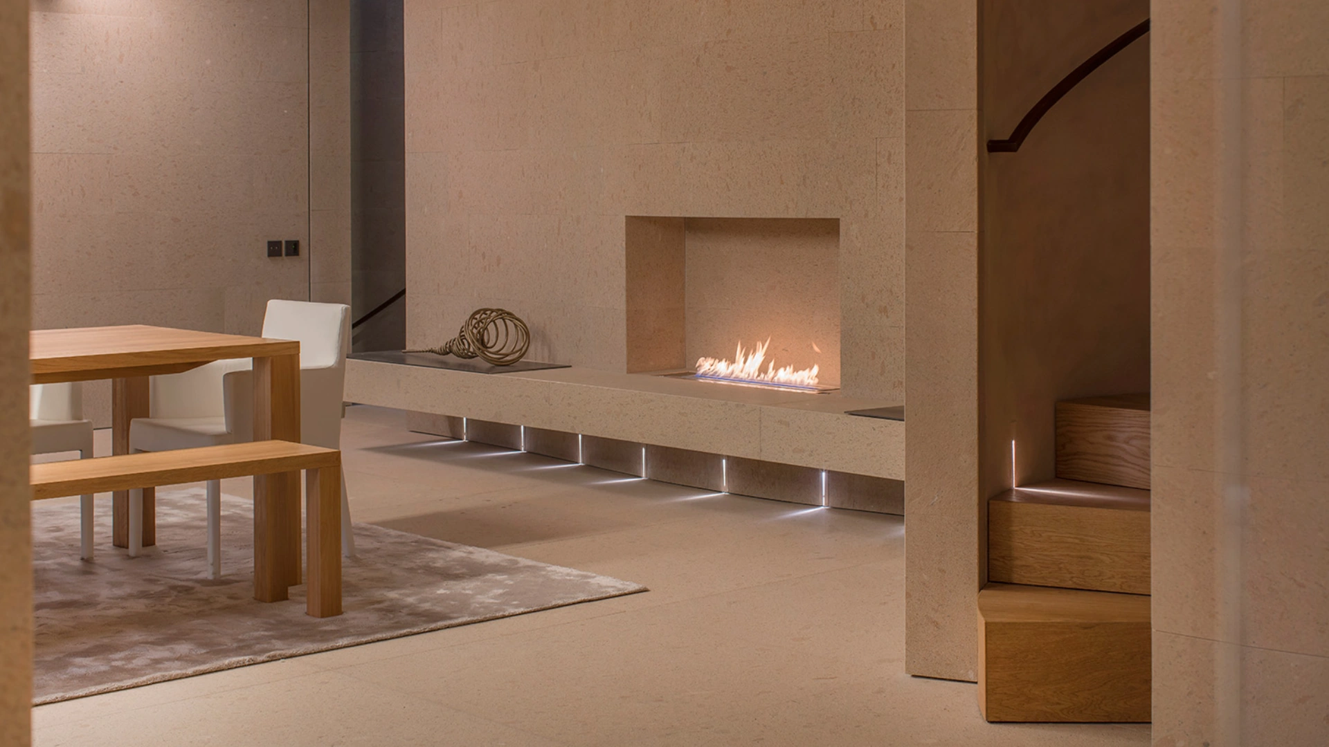 Claudio Silvestrin warm minimalist interiors featuring natural stone, soft light, and refined architectural spaces that define contemporary minimalist luxury homes.