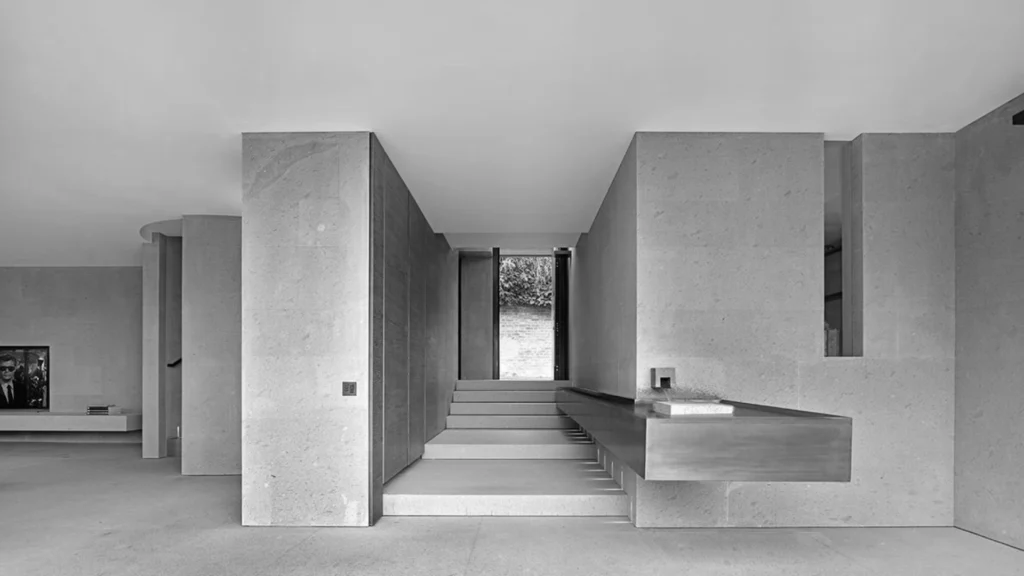 Claudio Silvestrin warm minimalist interiors featuring natural stone, soft light, and refined architectural spaces that define contemporary minimalist luxury homes.