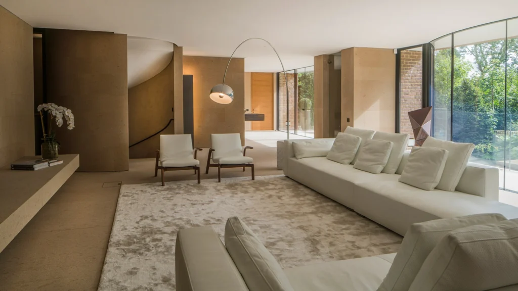Claudio Silvestrin warm minimalist interiors featuring natural stone, soft light, and refined architectural spaces that define contemporary minimalist luxury homes.