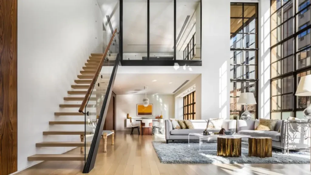 Luxury Tribeca duplex apartments featuring double-height living rooms, sculptural staircases, mezzanine galleries, and refined Tribeca loft interiors demonstrating sophisticated duplex apartment layout design.