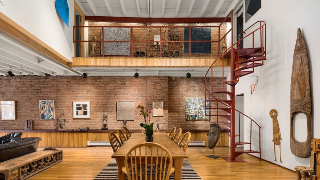 Luxury Tribeca duplex apartments featuring double-height living rooms, sculptural staircases, mezzanine galleries, and refined Tribeca loft interiors demonstrating sophisticated duplex apartment layout design.