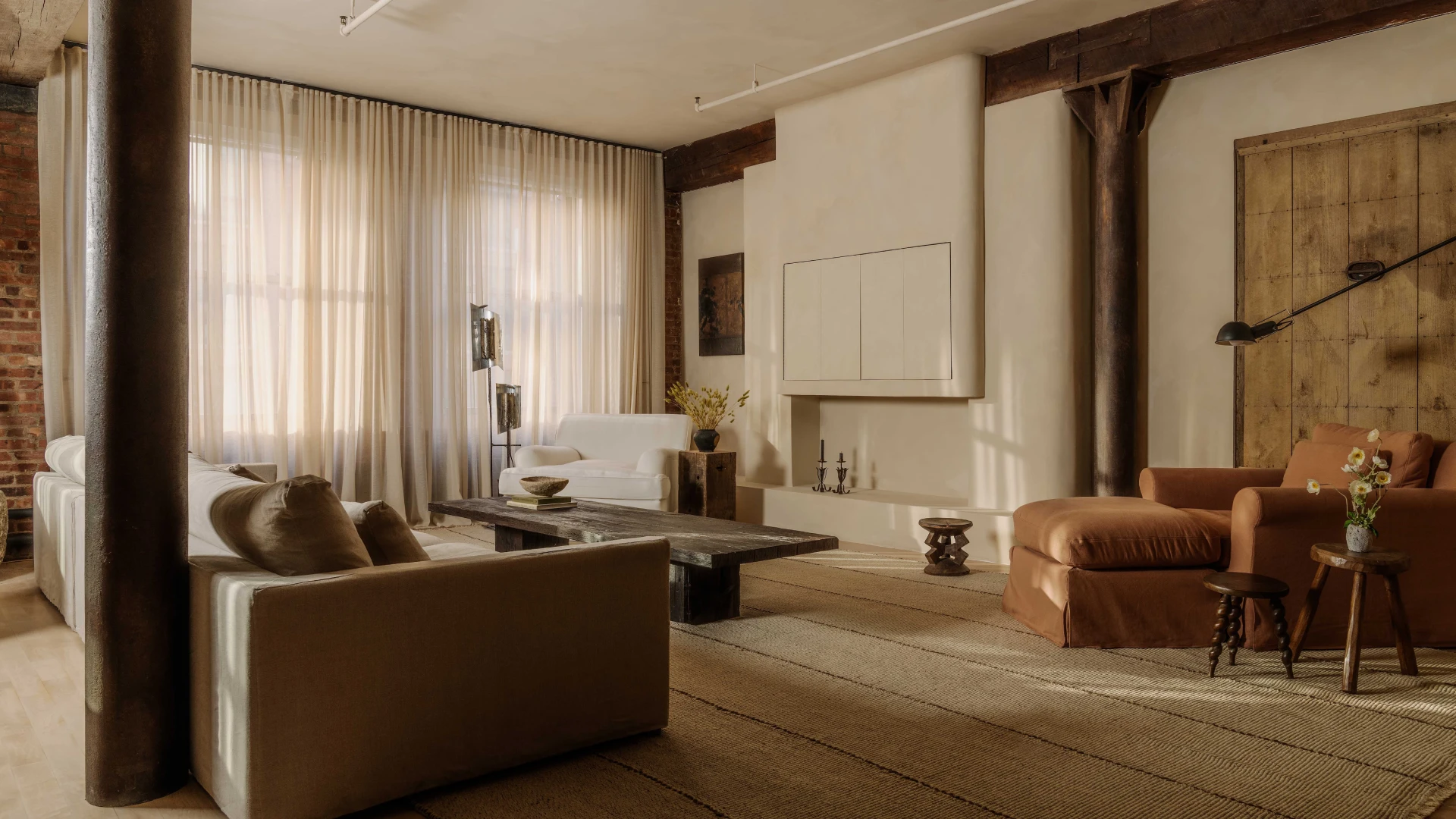 Luxury Tribeca duplex apartments featuring double-height living rooms, sculptural staircases, mezzanine galleries, and refined Tribeca loft interiors demonstrating sophisticated duplex apartment layout design.
