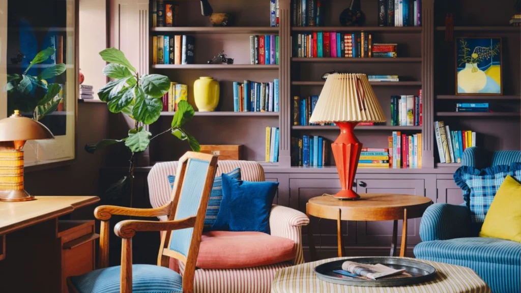 Luxury home library design with floor-to-ceiling bookshelves, a comfortable reading chair, and a marble side table creating an elegant reading corner layout.