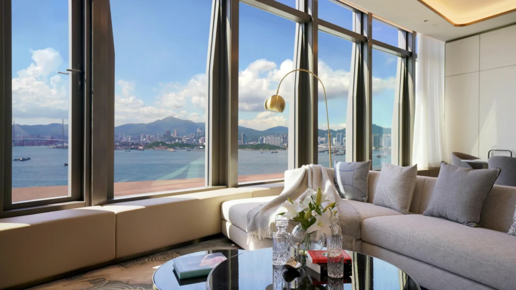 Luxury Hong Kong high-rise apartment living room with panoramic Victoria Harbour skyline view