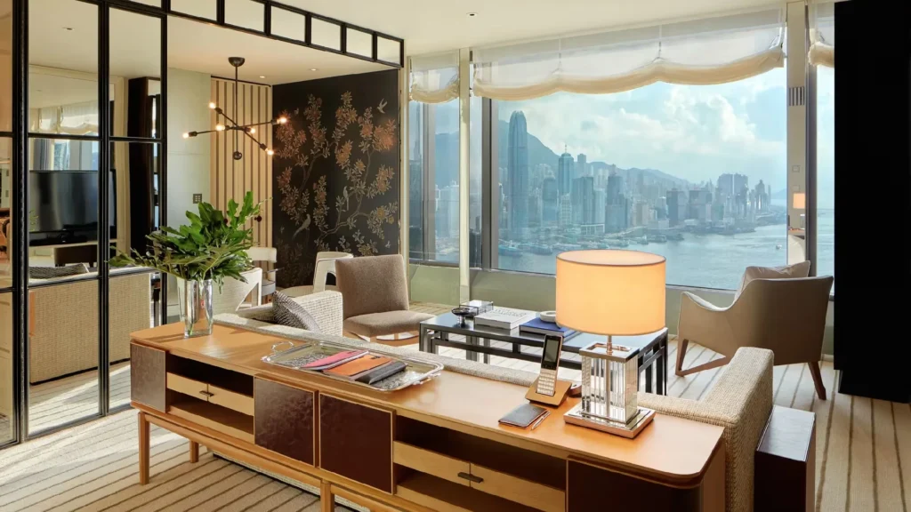Luxury Hong Kong high-rise apartment living room with panoramic Victoria Harbour skyline view