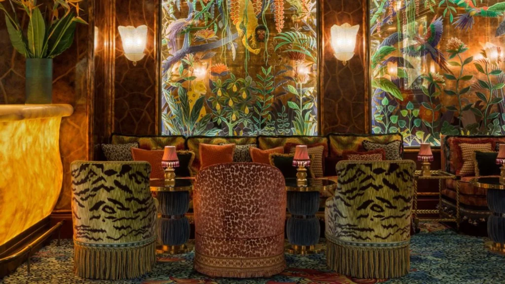 Theatrical hospitality interior design by Martin Brudnizki featuring luxurious maximalist interiors in iconic restaurants and private clubs.