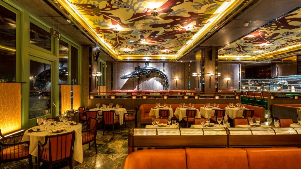 Theatrical hospitality interior design by Martin Brudnizki featuring luxurious maximalist interiors in iconic restaurants and private clubs.