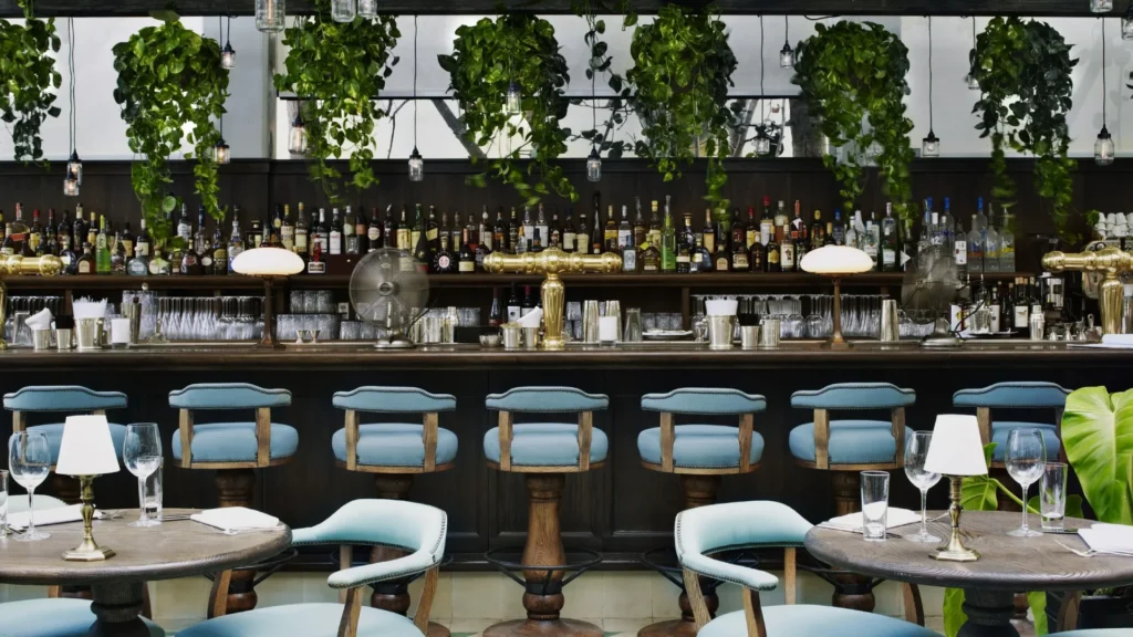 Theatrical hospitality interior design by Martin Brudnizki featuring luxurious maximalist interiors in iconic restaurants and private clubs.