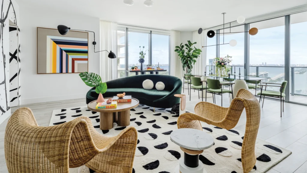 Miami beachfront condo living room with panoramic Atlantic Ocean views and contemporary coastal luxury interior design.