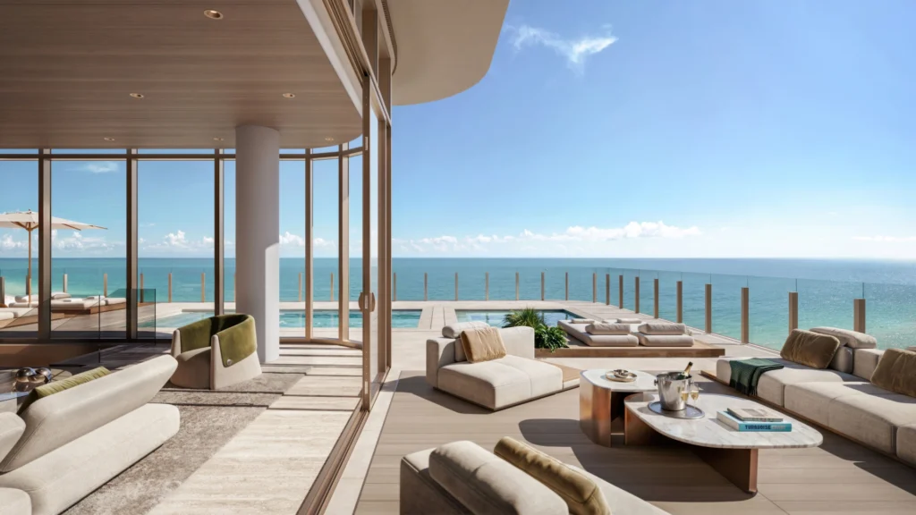 Miami beachfront condo living room with panoramic Atlantic Ocean views and contemporary coastal luxury interior design.