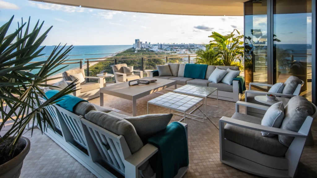Miami beachfront condo living room with panoramic Atlantic Ocean views and contemporary coastal luxury interior design.