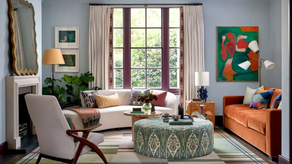 Elegant Notting Hill townhouse living room with a sofa placed between tall French doors, showcasing refined London period home interior design with natural light and garden views.