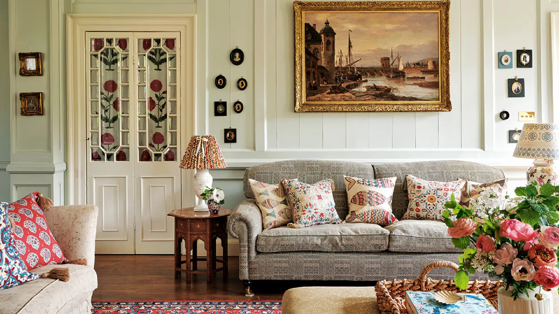 Elegant traditional interiors inspired by Rita Konig featuring classic interior design, layered textiles, antique furniture, warm lighting, and timeless British-style living spaces.