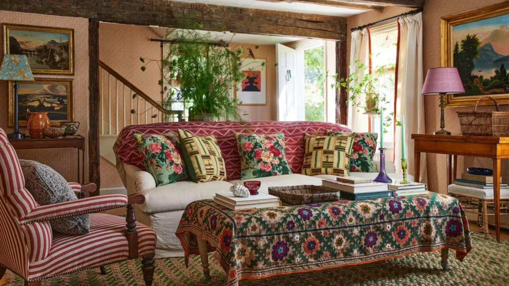 Elegant traditional interiors inspired by Rita Konig featuring classic interior design, layered textiles, antique furniture, warm lighting, and timeless British-style living spaces.