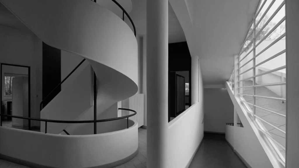 Villa Savoye by Le Corbusier in Poissy, France, iconic example of modernist architecture featuring white facade, ribbon windows, pilotis columns, and minimalist modernist design.