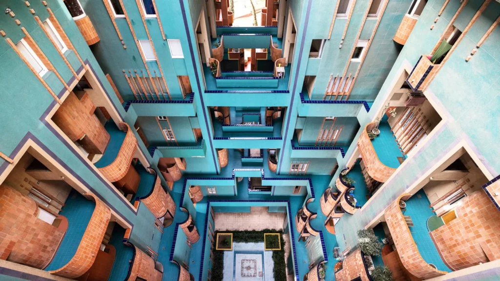 Walden 7 residential complex by Ricardo Bofill in Barcelona, a landmark of postmodern residential architecture featuring terracotta towers and vibrant interior courtyards.
