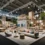 Modern design fair booth featuring modular structure, integrated lighting, and curated interior display, representing design fairs for luxury brands