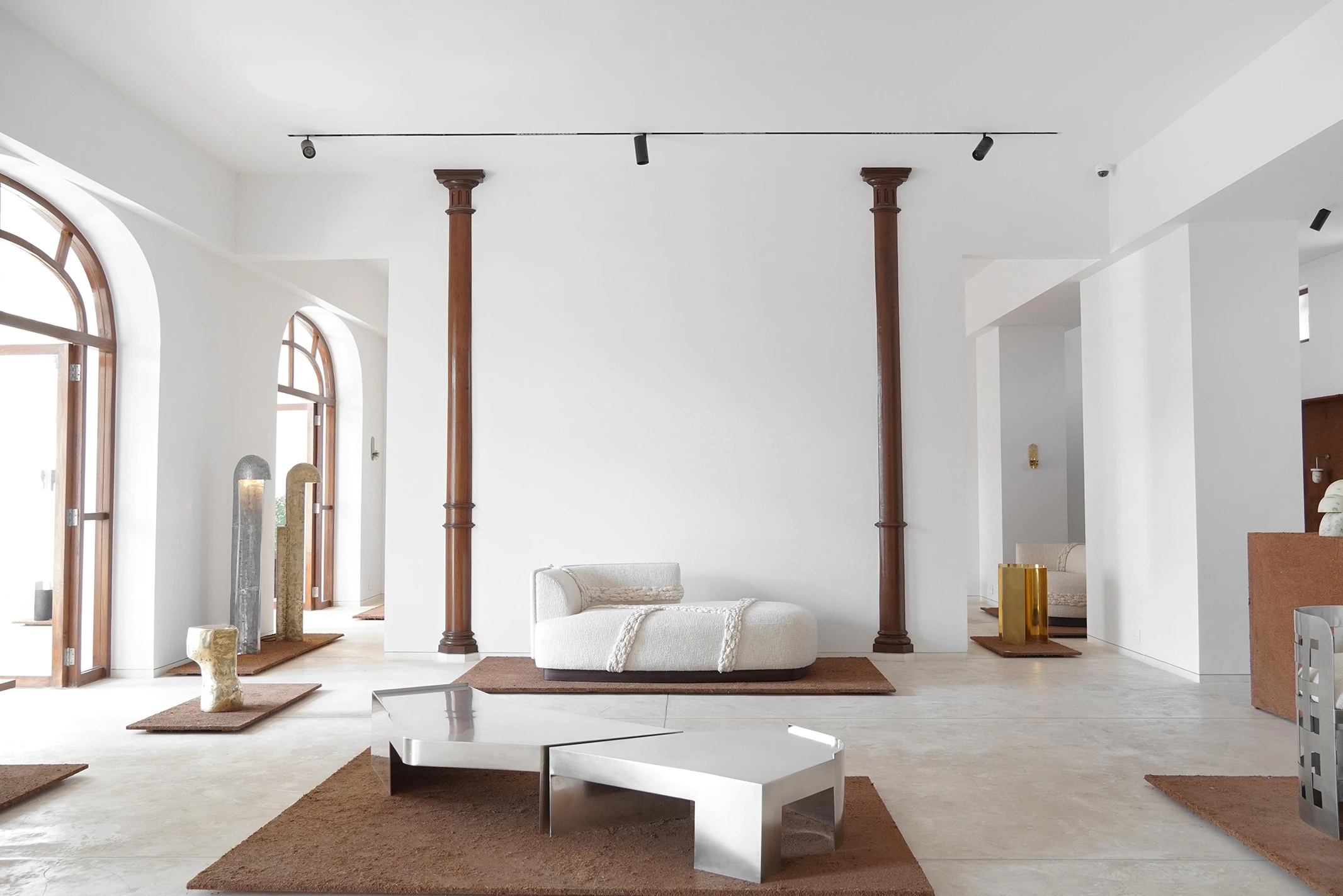 Curated collectible design gallery featuring sculptural furniture, handcrafted materials, and artistic interior composition, representing design fairs for luxury brands