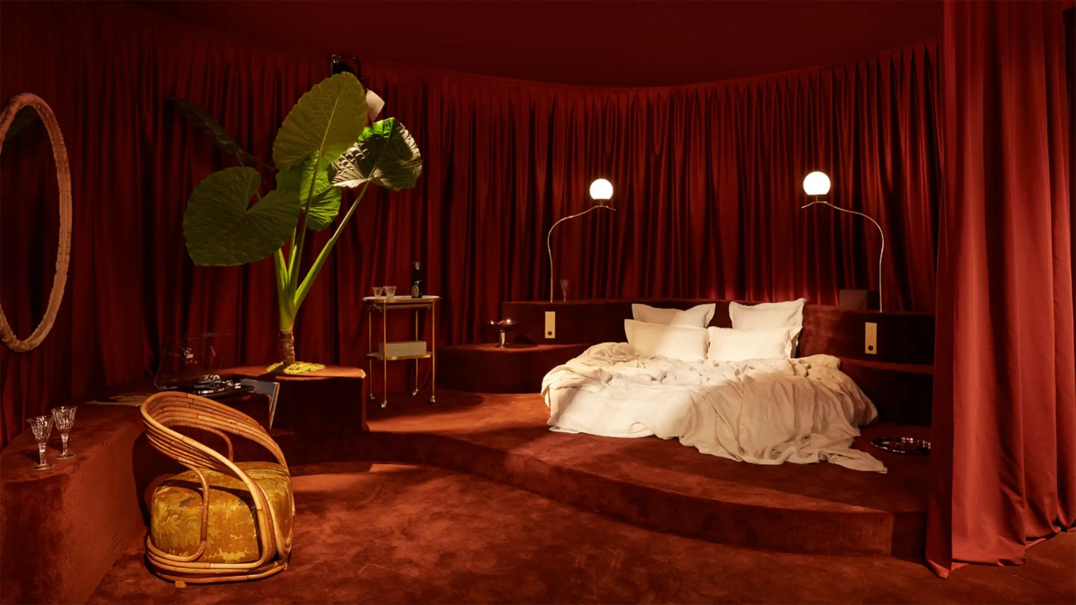 Luxury furniture exhibitor stand showcase at EquipHotel Paris 2026 featuring high-end bed and tailored contract armchair
