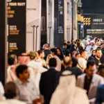 Crowded exhibition hall at INDEX Saudi Arabia 2026 with interior design professionals and visitors exploring trade stands at RICEC.