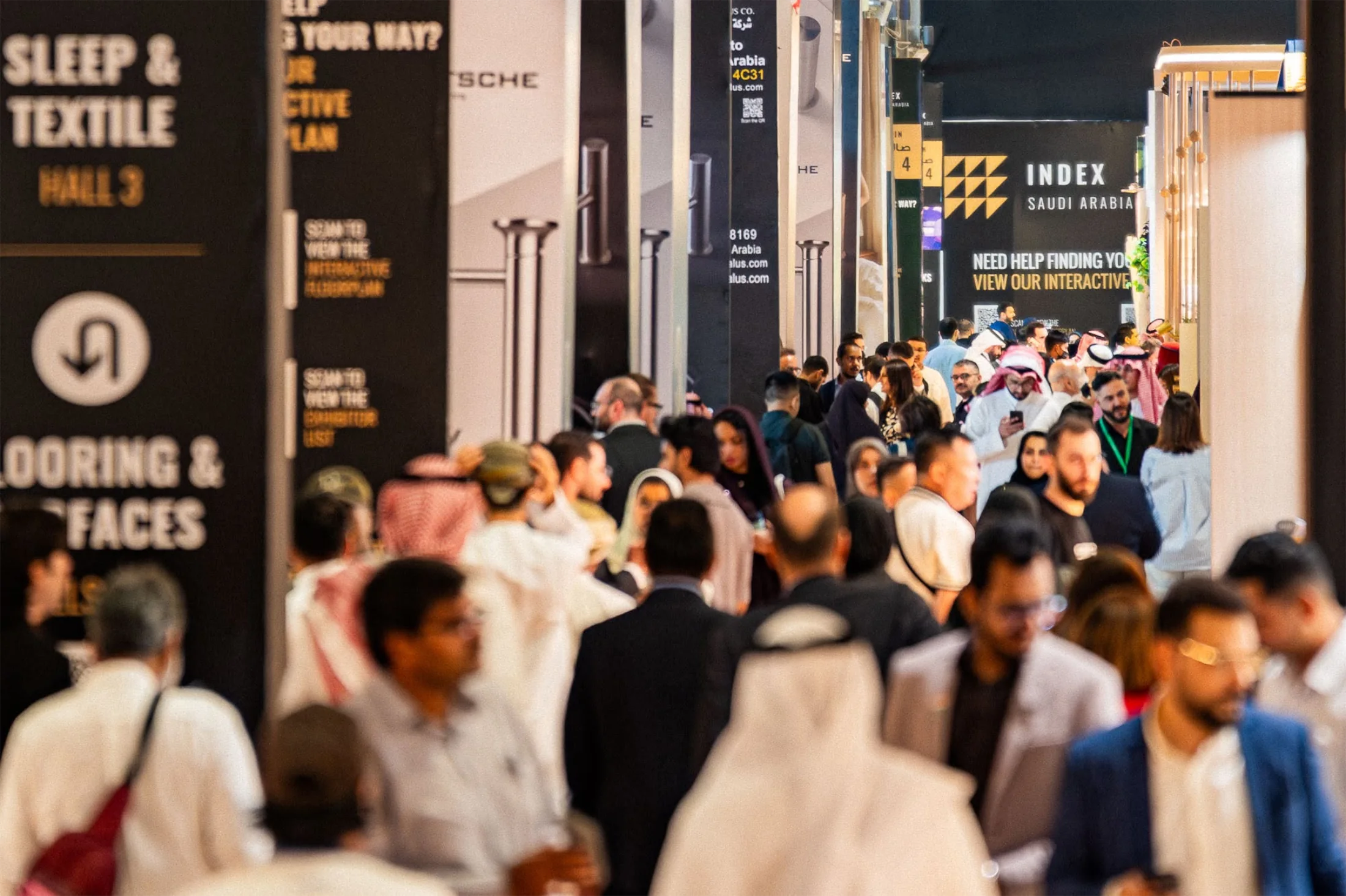 Crowded exhibition hall at INDEX Saudi Arabia 2026 with interior design professionals and visitors exploring trade stands at RICEC.
